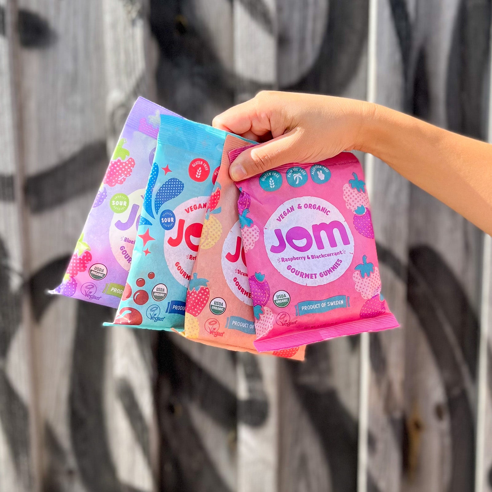 JOM Organic Candy Full Range USA Complete Flavor Pack Holding Bags in Hand