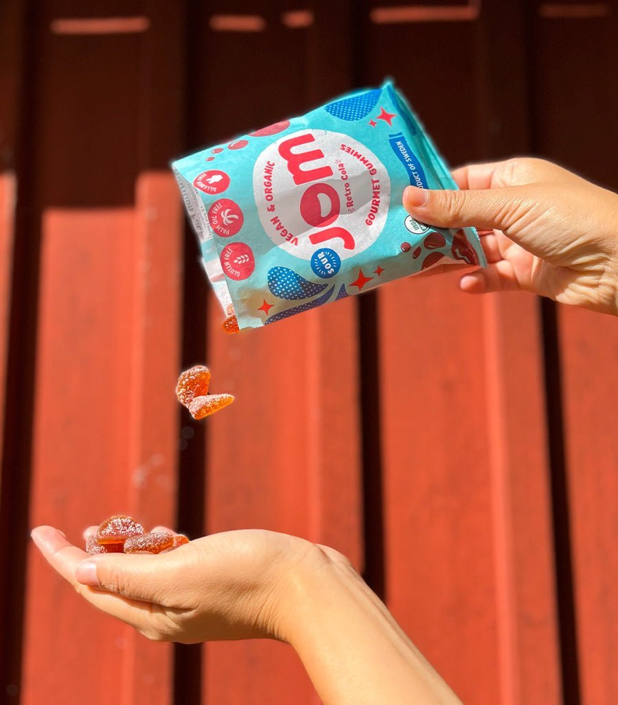 Organic Candy JOM Sour Retro Cola Plant-Based Gummies Pouring Candy in Hand USA