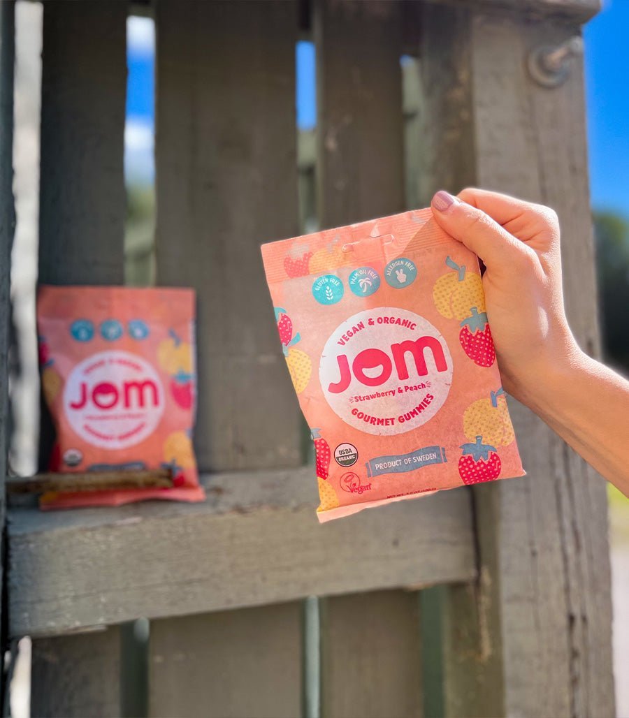 Organic Candy JOM Strawberry and Peach Plant Based Vegan Gummies Holding Bag in Hand USA