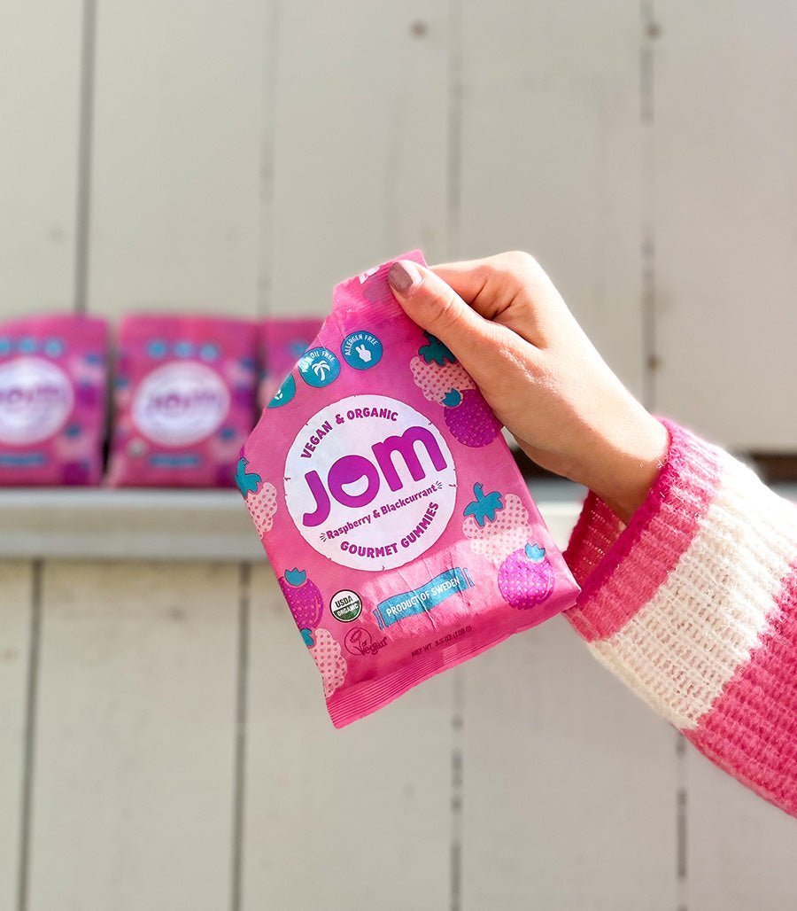 Organic Candy JOM Raspberry and Blackcurrant Vegan Gummies Holding Bag